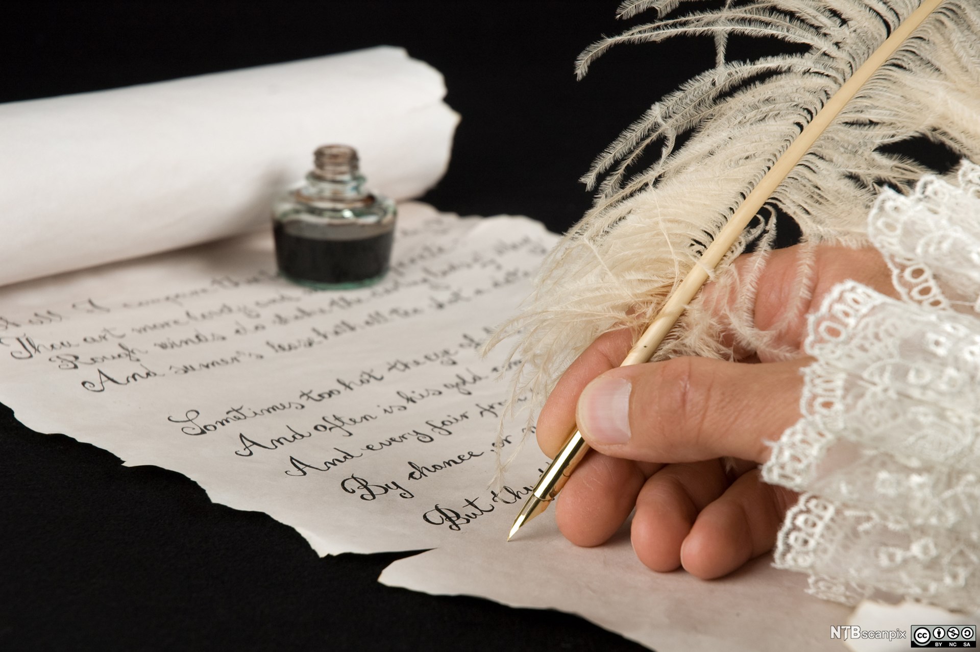 Hand writing poetry with a qull pen