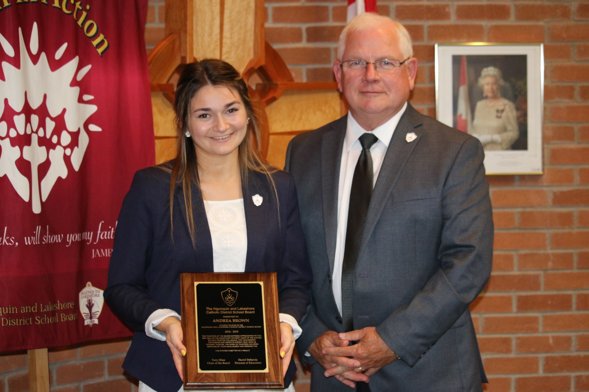 Chair of the Board, Terry Shea presents outgoing Student Trustee with a token of appreciation