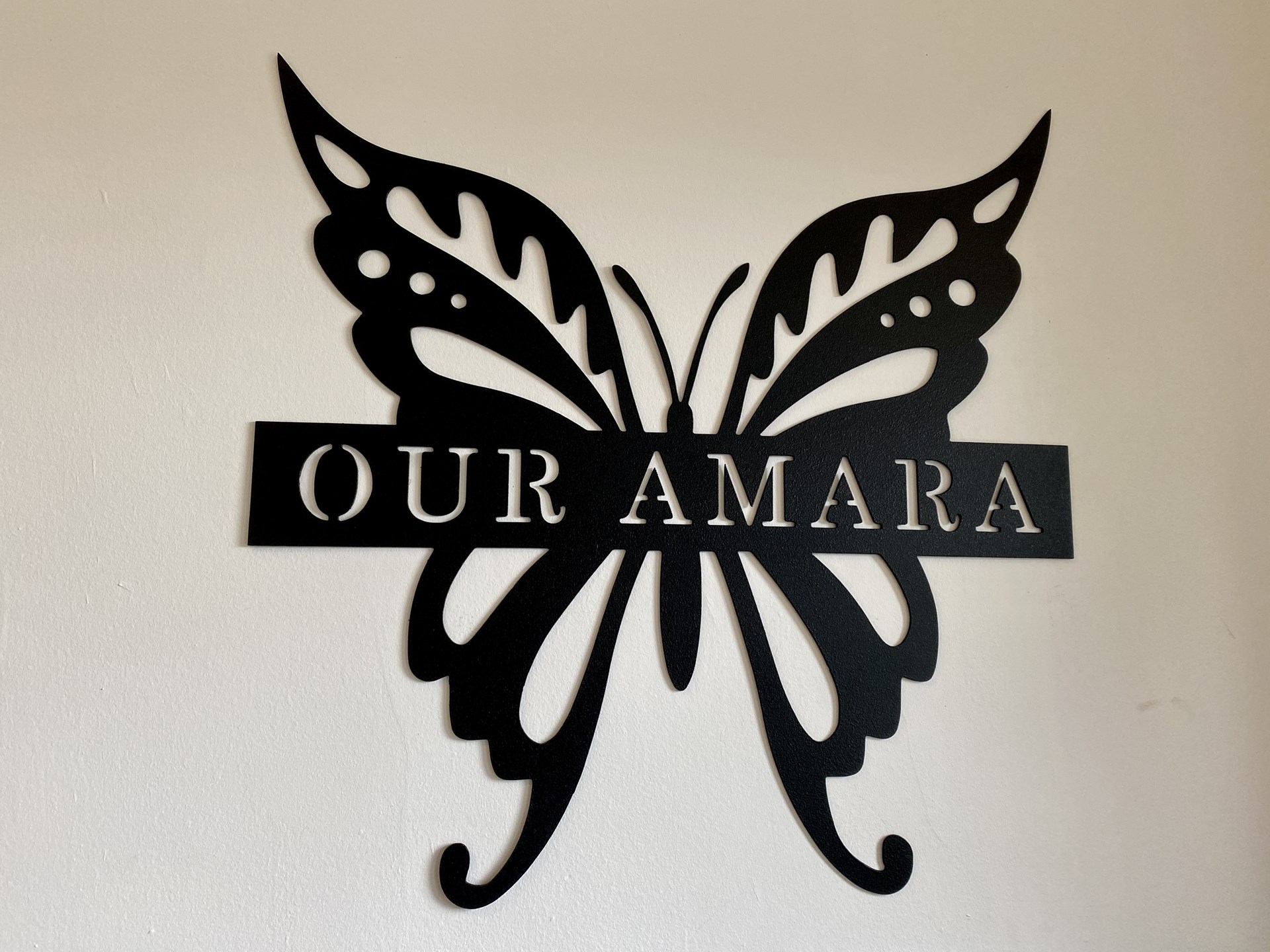 Image of a butterfly with the words "Our Amara"