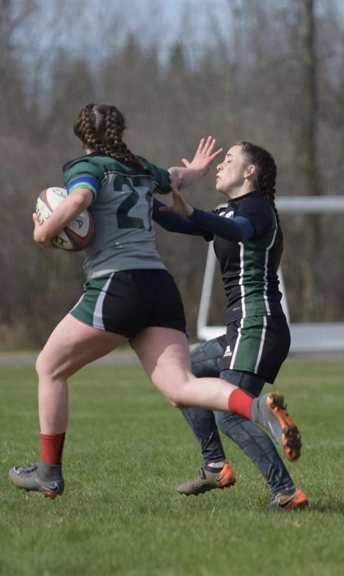 Two rugby players facing off