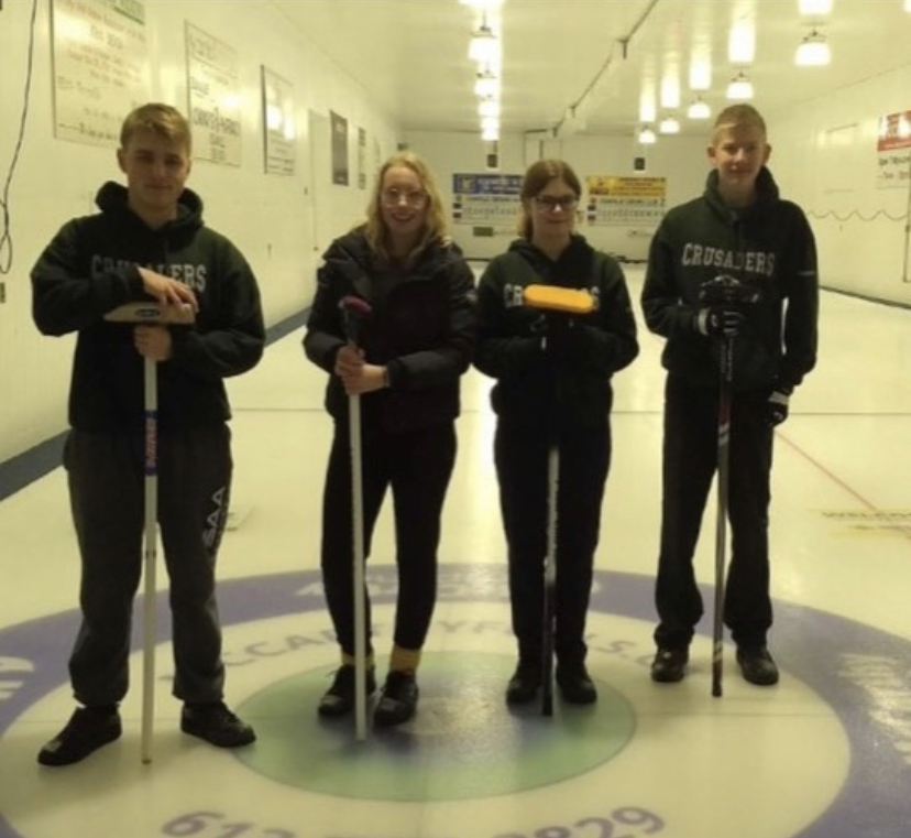 Curling team with brooms