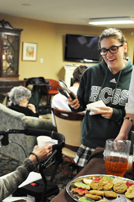 Students serve seniors tea and cookies.jpg