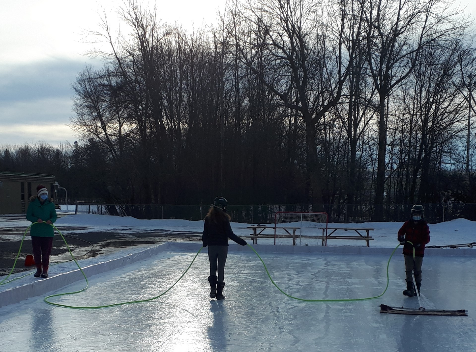 Grade 7/8 students resurfacing our skating rink in the morning.