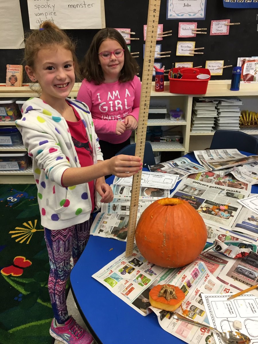 Student measuring pumpkin.jpg