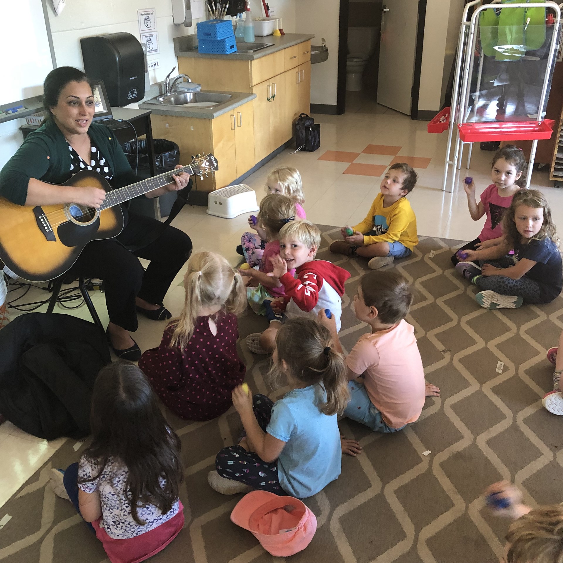 Children singing songs with teacher.