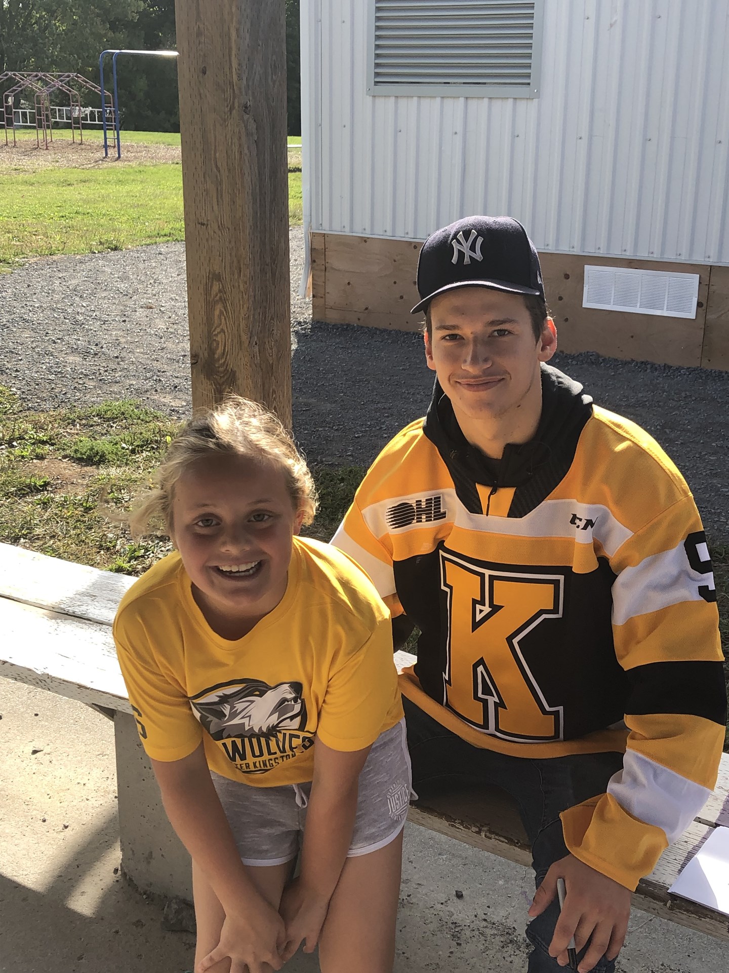Kingston Frontenacs player sitting with student.