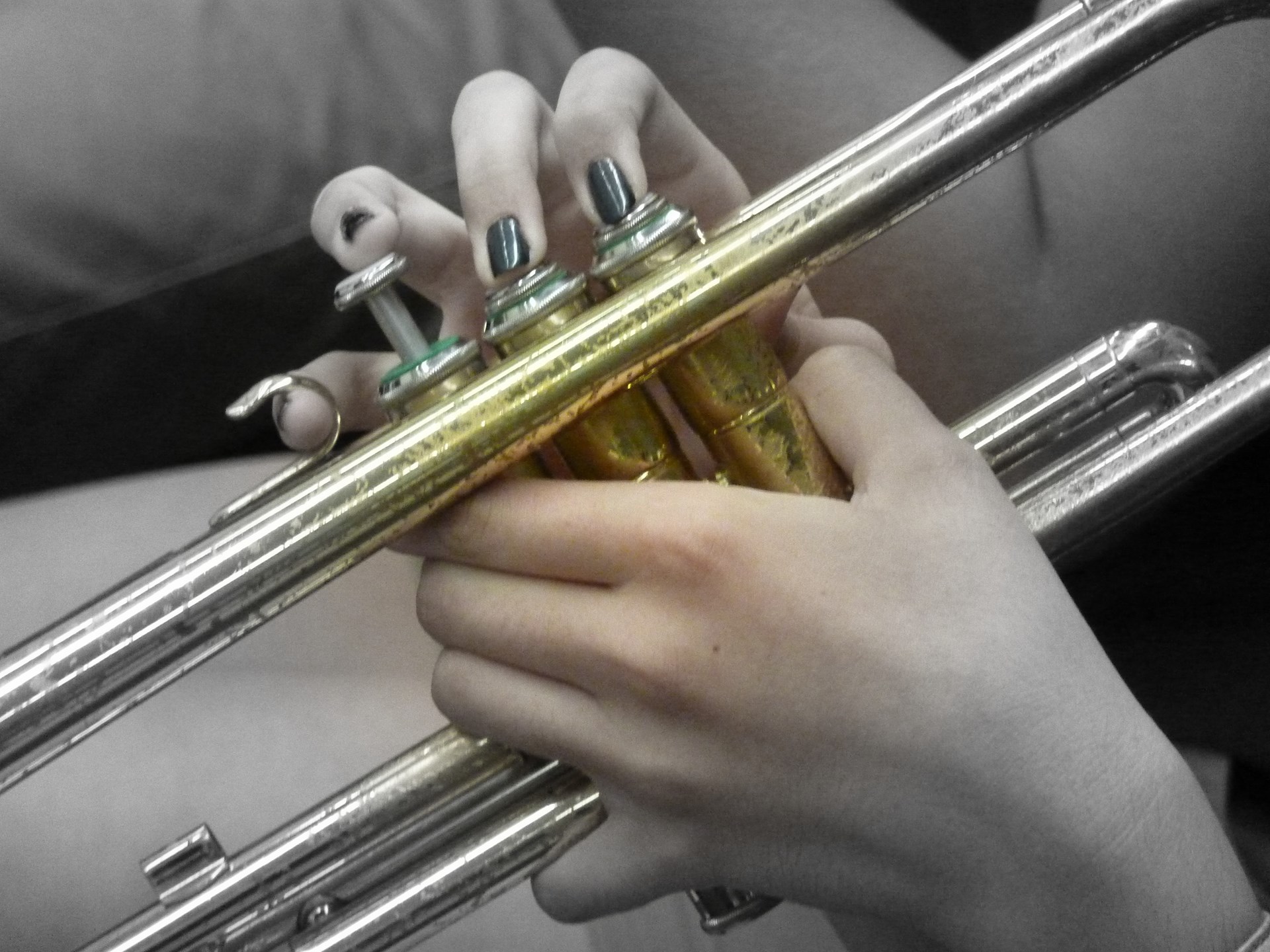Fingers playing a trombone