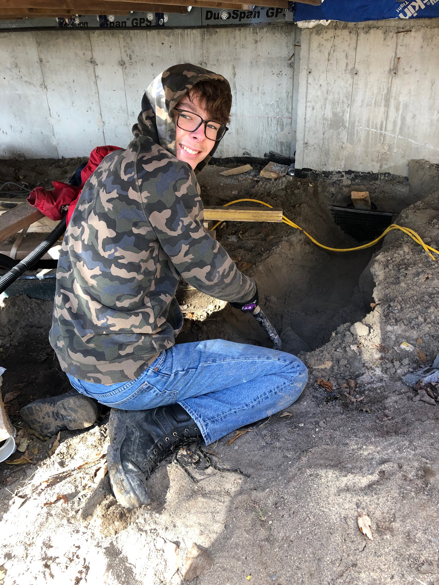 Student digging a foundation