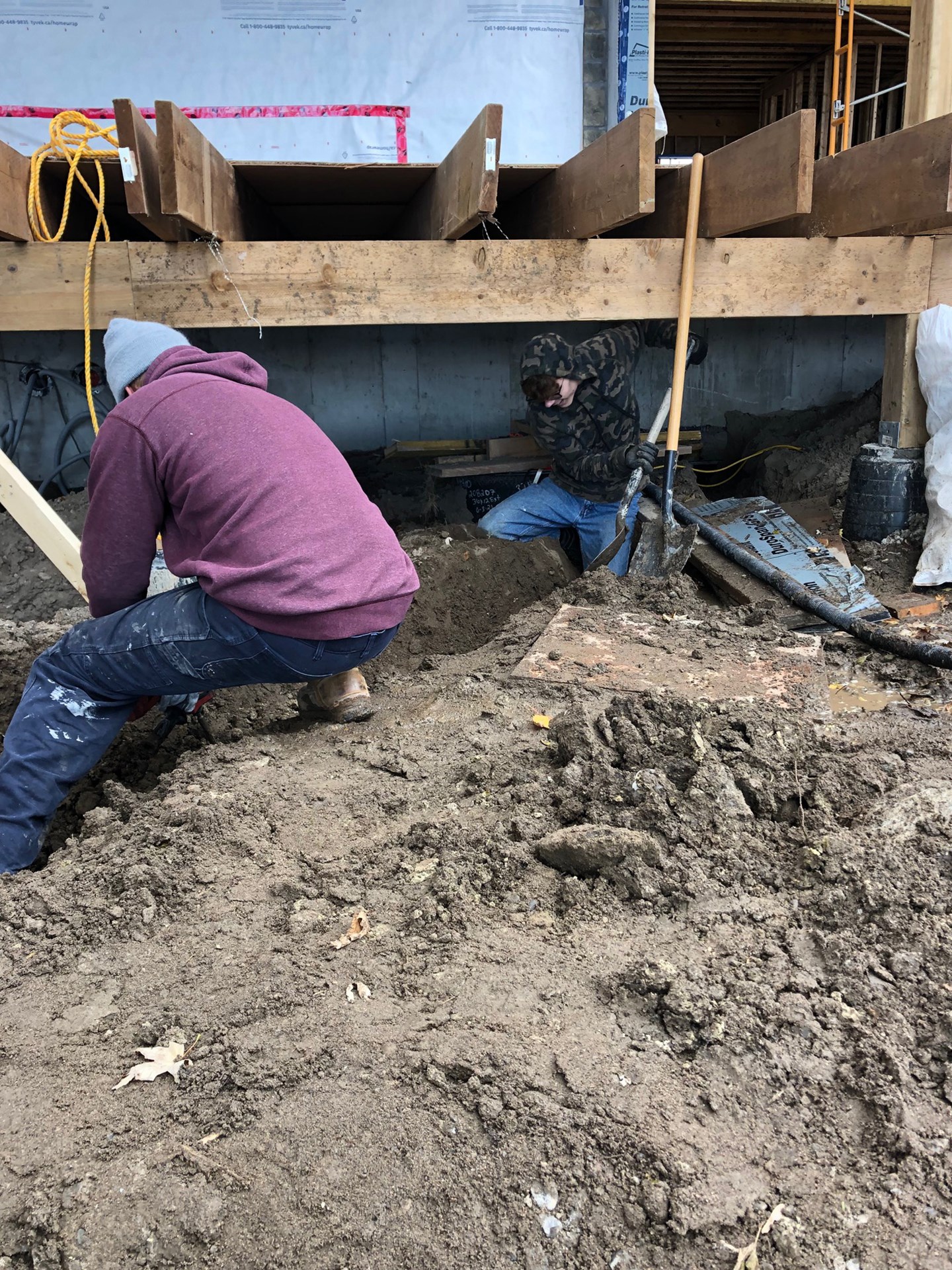 Student digging under deck
