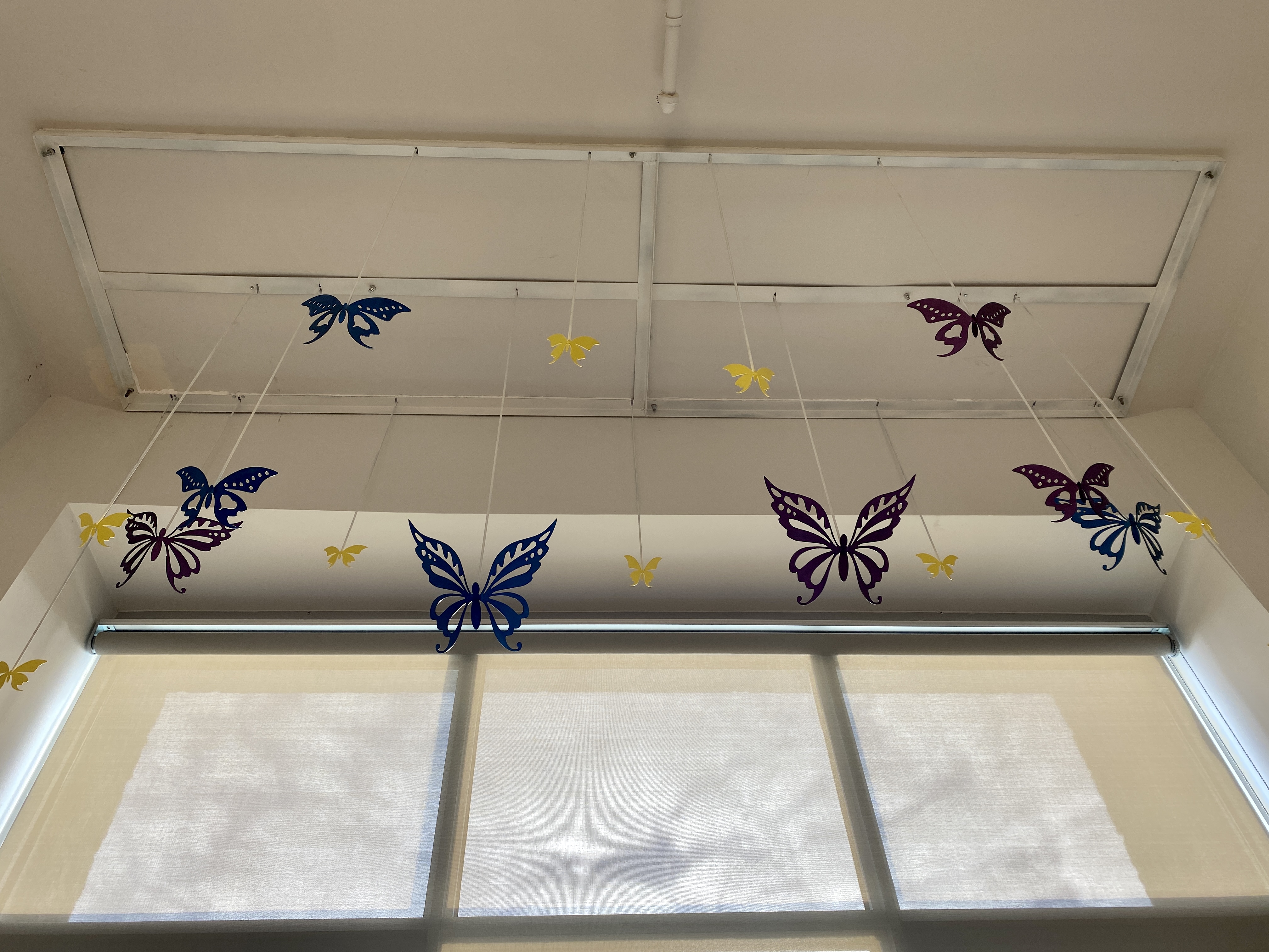 Image of paper butterflies hanging from the ceiling.